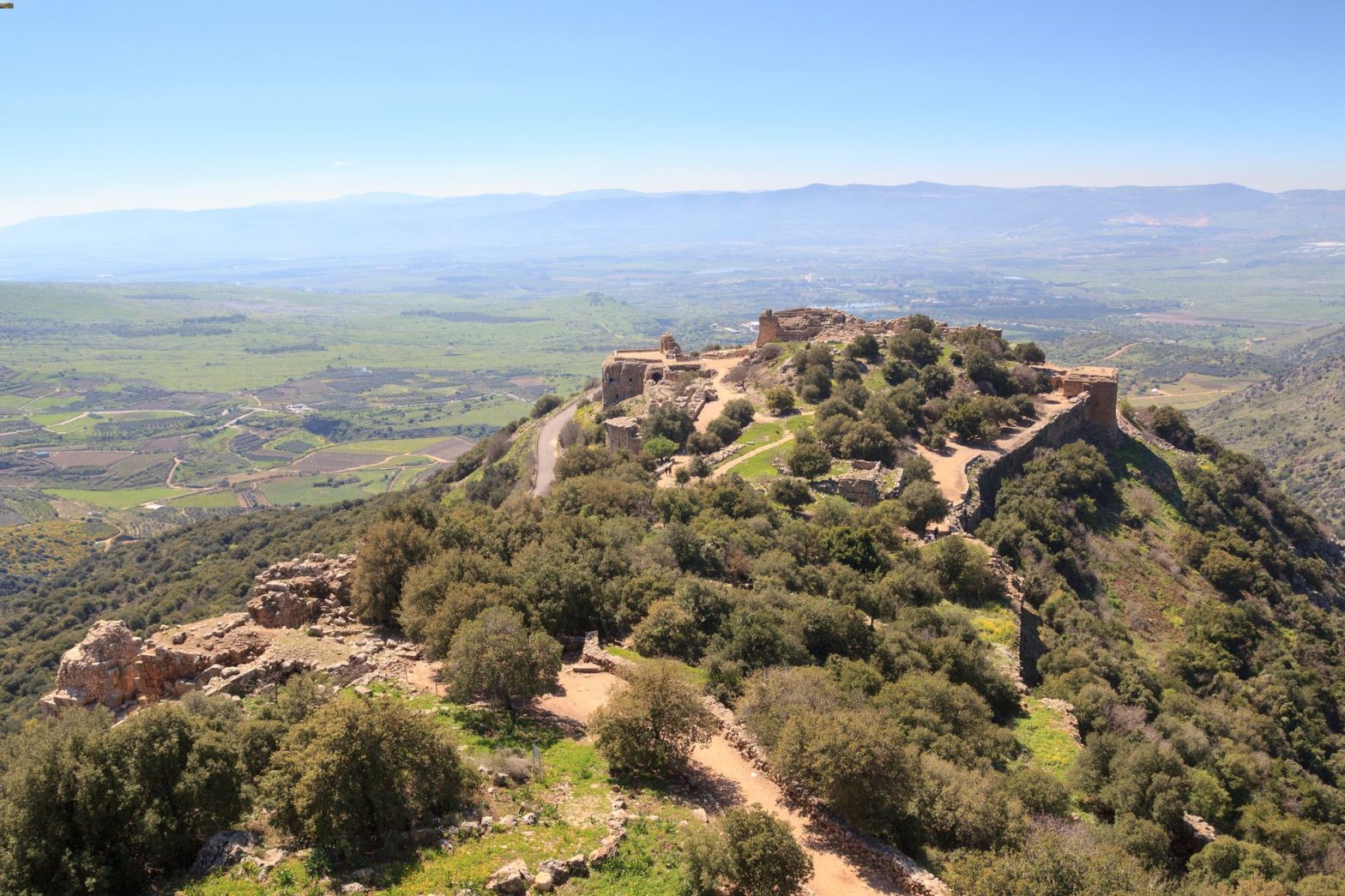 Hilltop ruins overlooking expansive valley